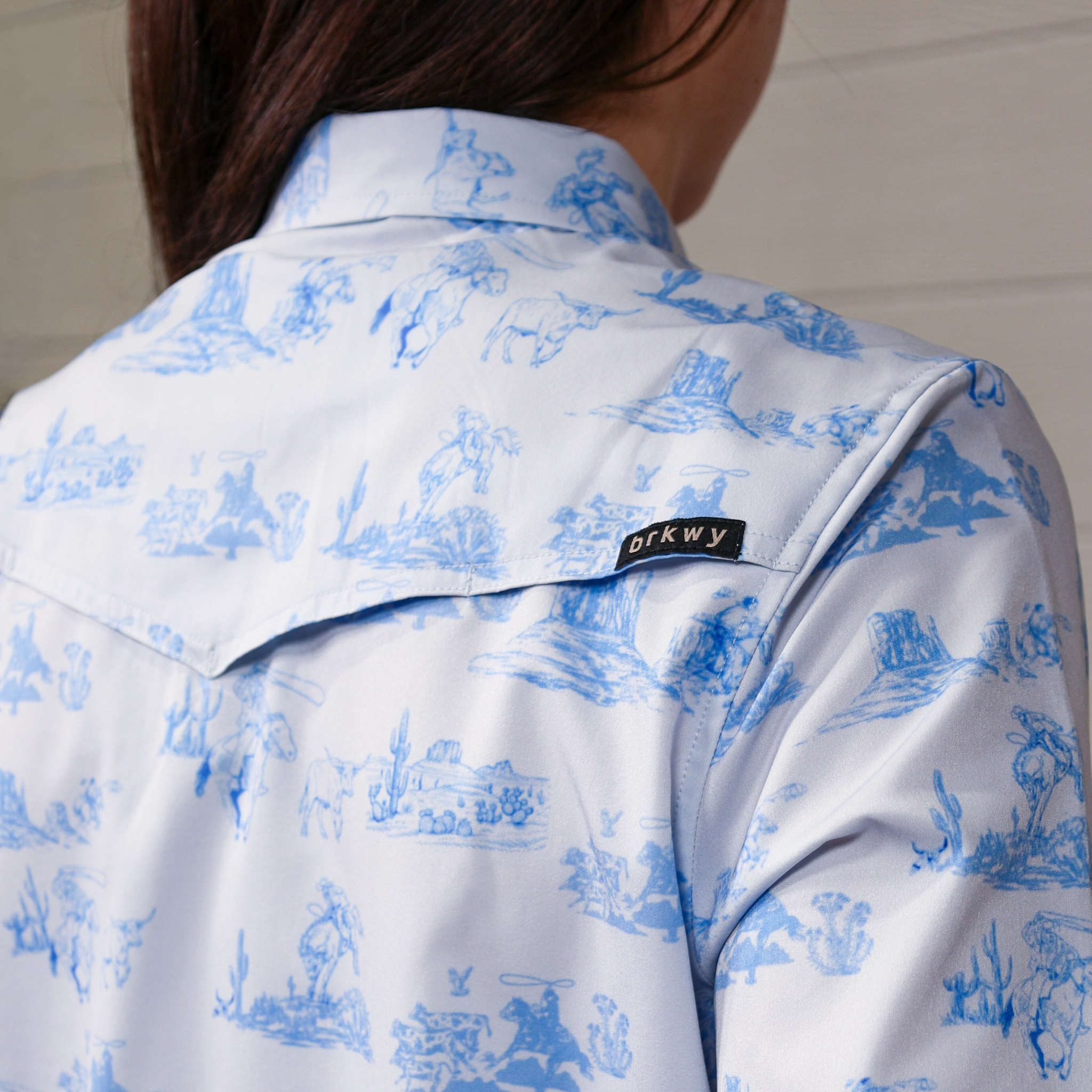 White shirt with blue pattern and 'brkwy' brand label. Back Facing.