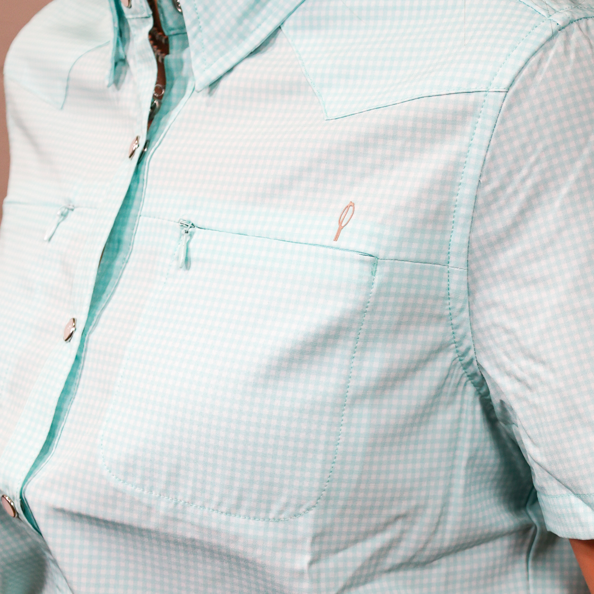 Light blue checkered short sleeve shirt with a zipper and pocket details.