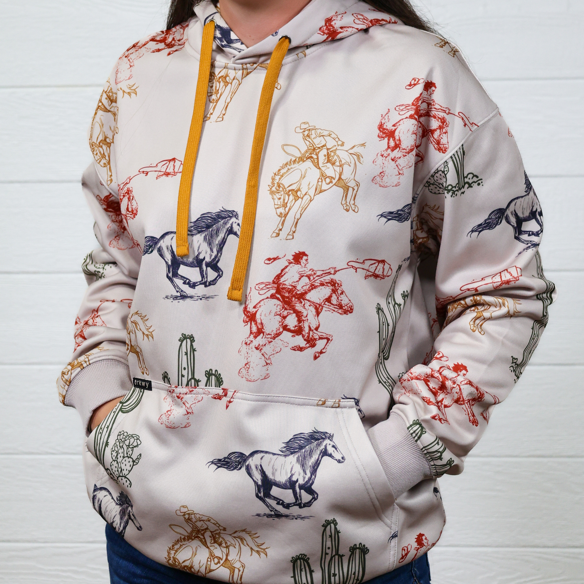 Hoodie with horse and cactus designs on a white background. front facing