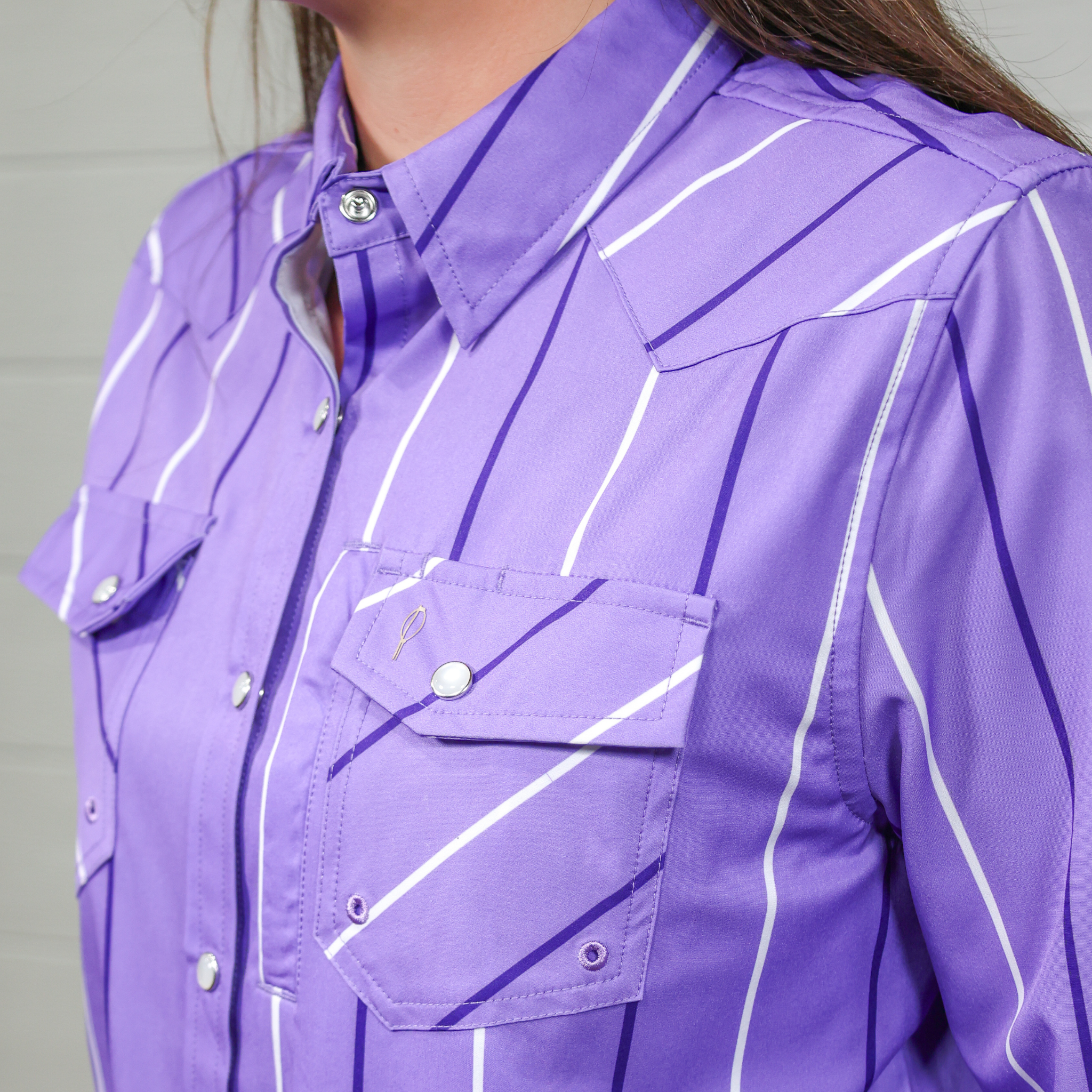 Close-up of a purple shirt with white lines on a white background