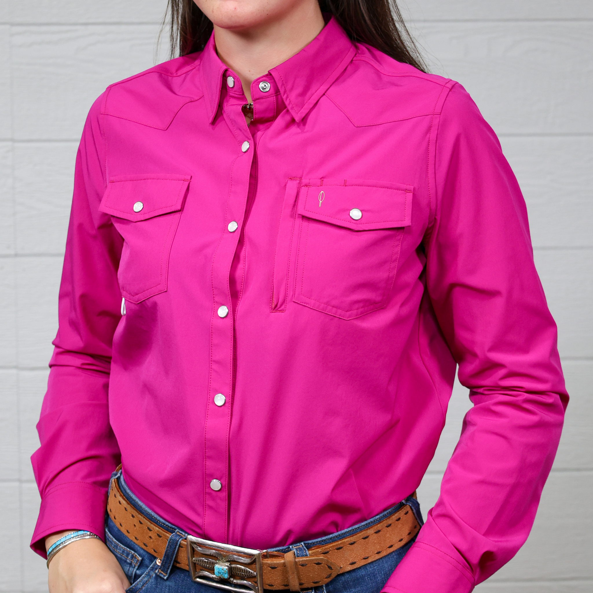 Person wearing a bright pink shirt with a white background. Forward Facing