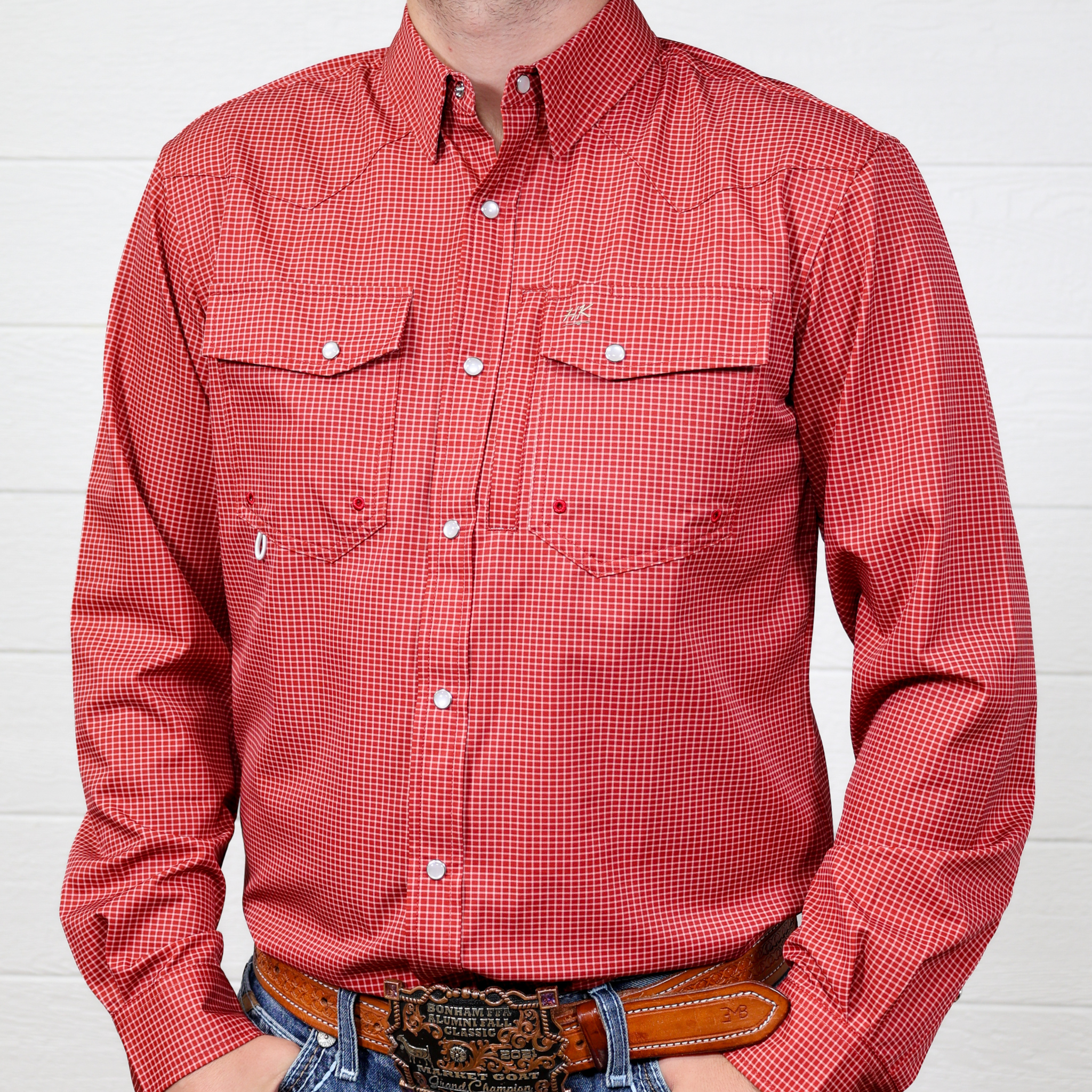 Red checkered shirt worn by a person against a white background. front facing.
