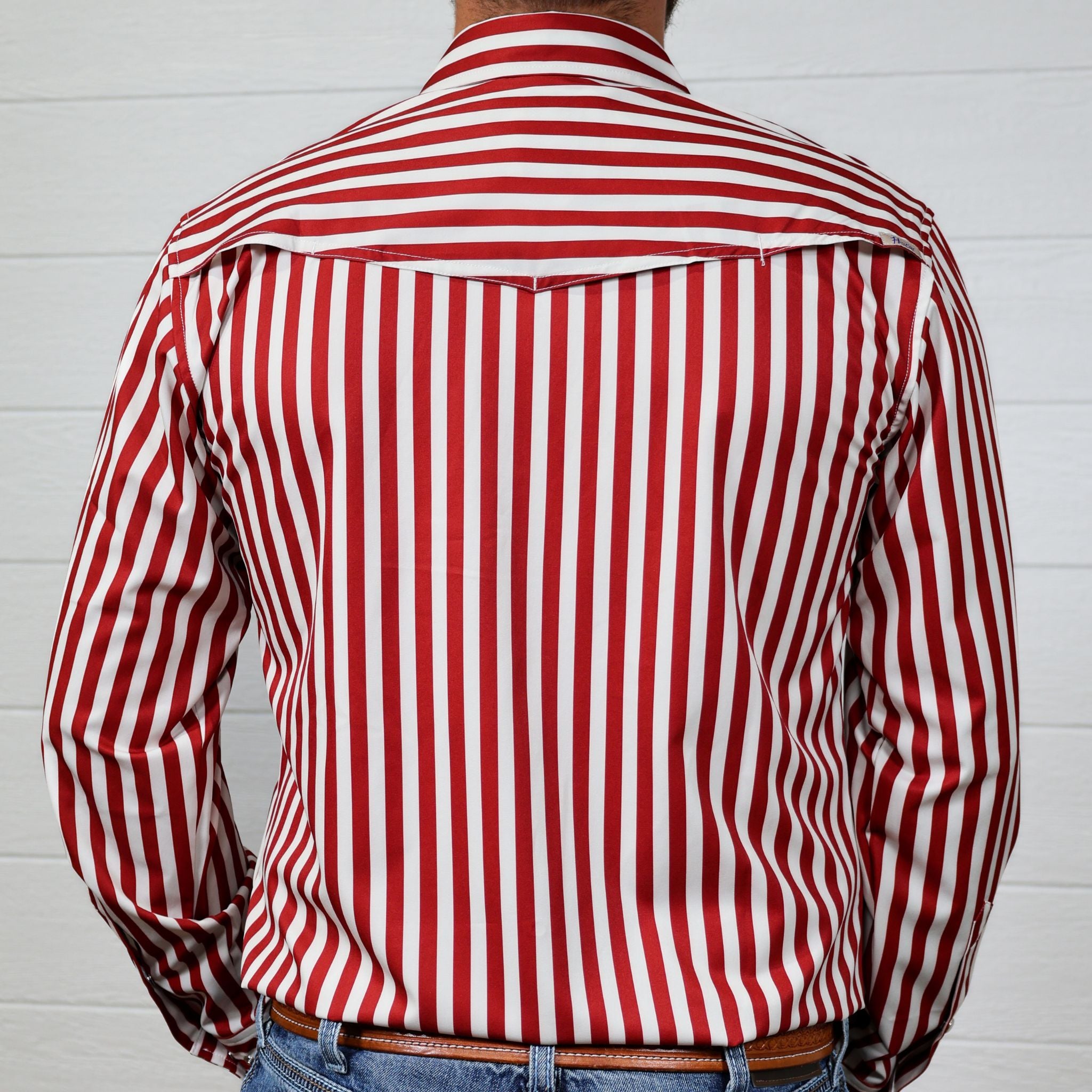 Red and white striped shirt worn by a person against a white background showing the back 