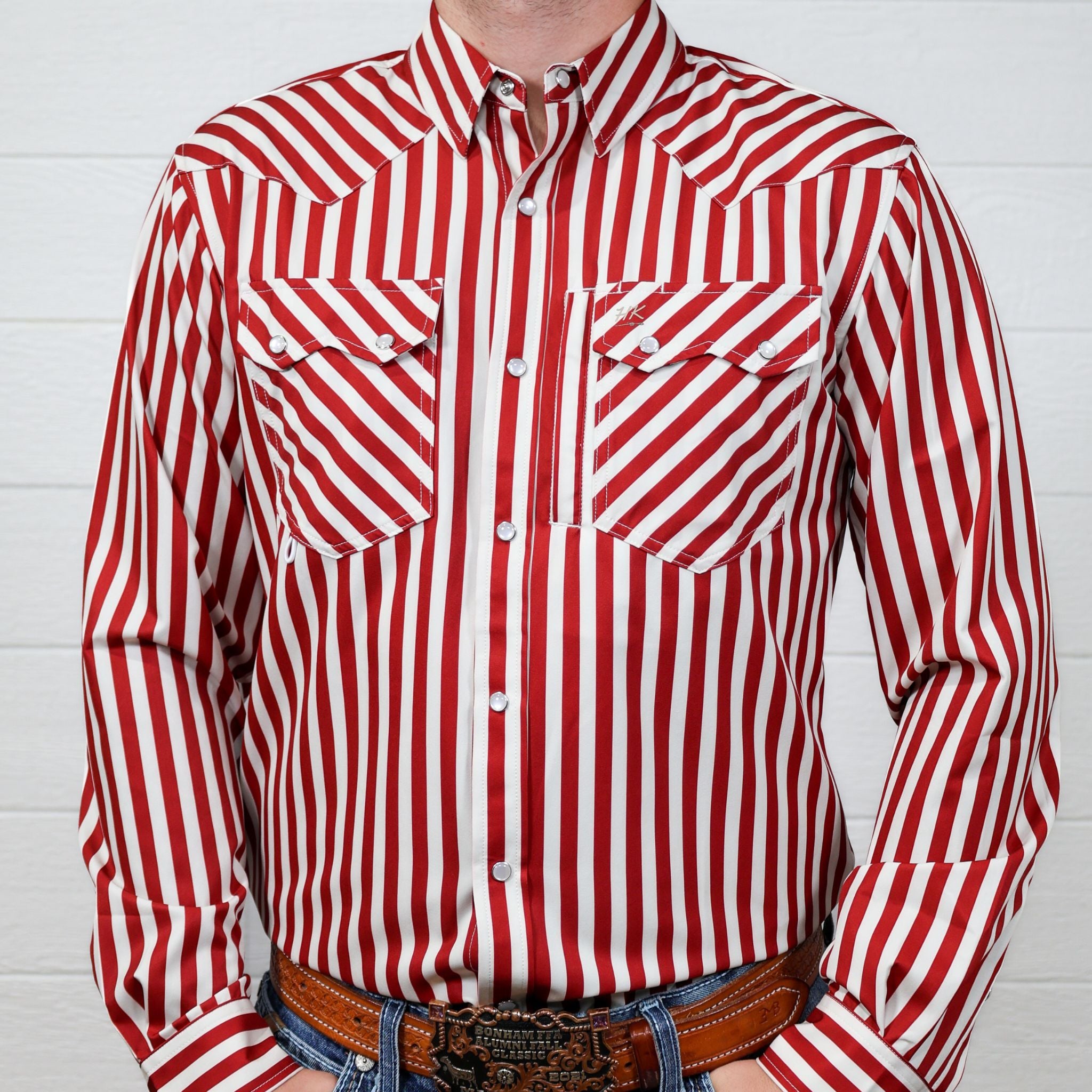 Front of Red and white striped shirt worn by a person against a white background
