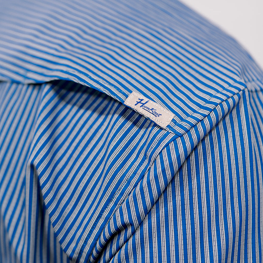 Close-up of a blue and white striped shirt with a brand label.
