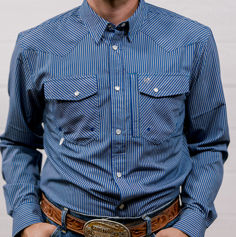 Man wearing a blue striped shirt with a belt and buckle against a plain background. front facing.