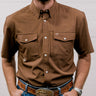 Man wearing a brown shirt and blue jeans with a belt buckle, standing against a plain background. Front Facing
