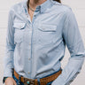 Woman wearing a light blue shirt and jeans against a plain background Showing the front 