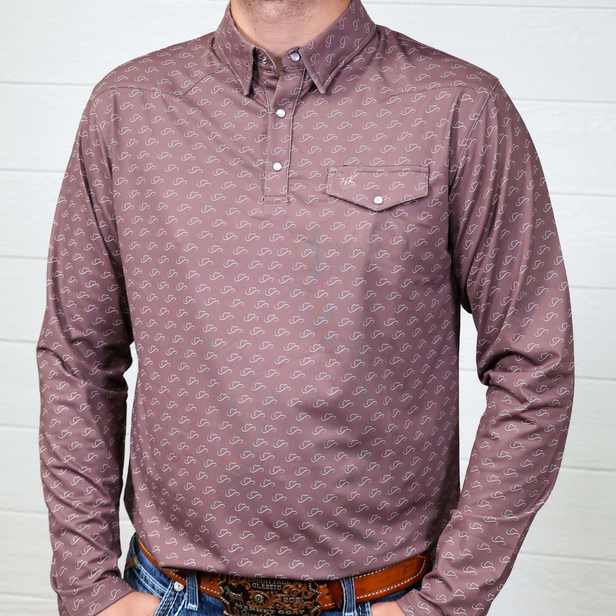 Man wearing a patterned long-sleeve polo against a white background showing the front