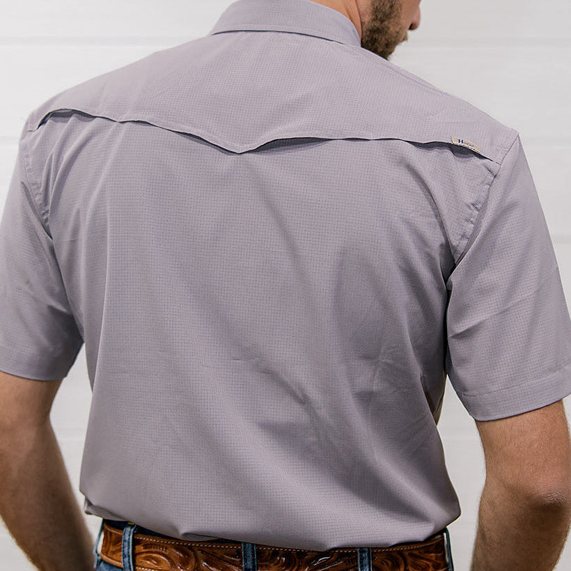 Man wearing a Purple short-sleeve shirt with a against a plain background showing the back 