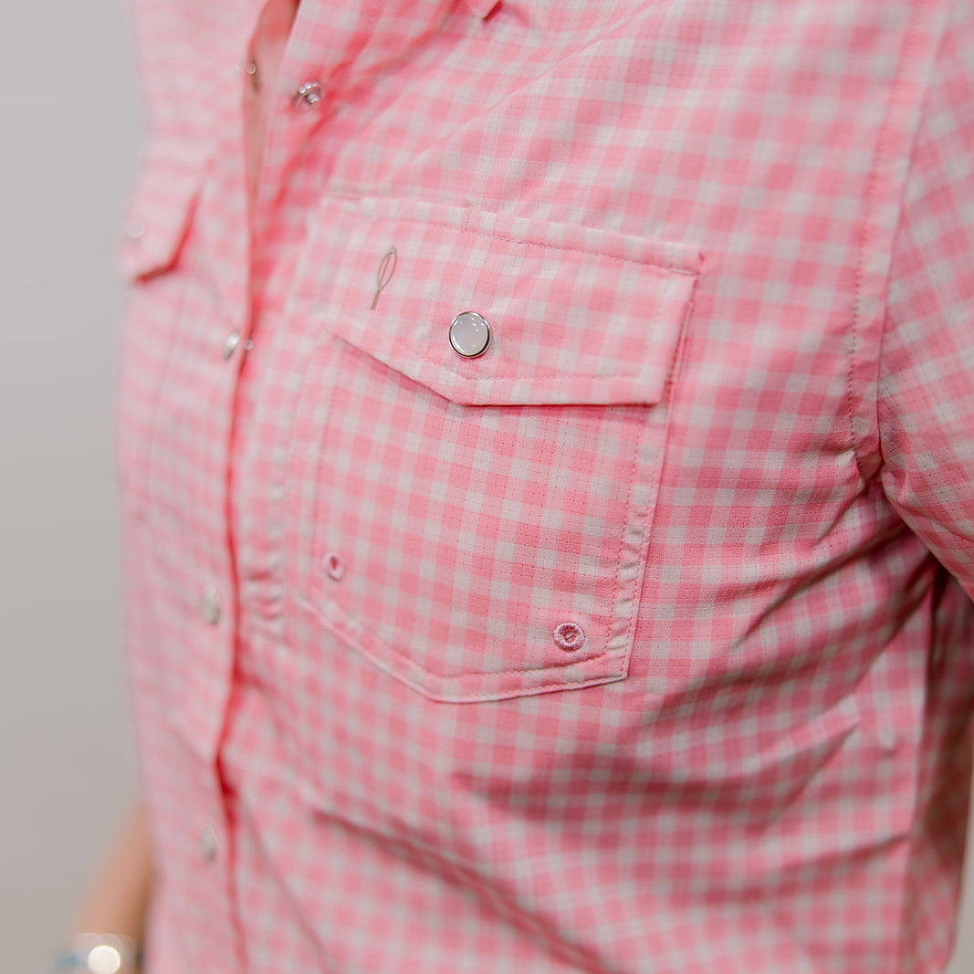 Close-up of a pink checkered shirt with a pocket and buttons. side facing
