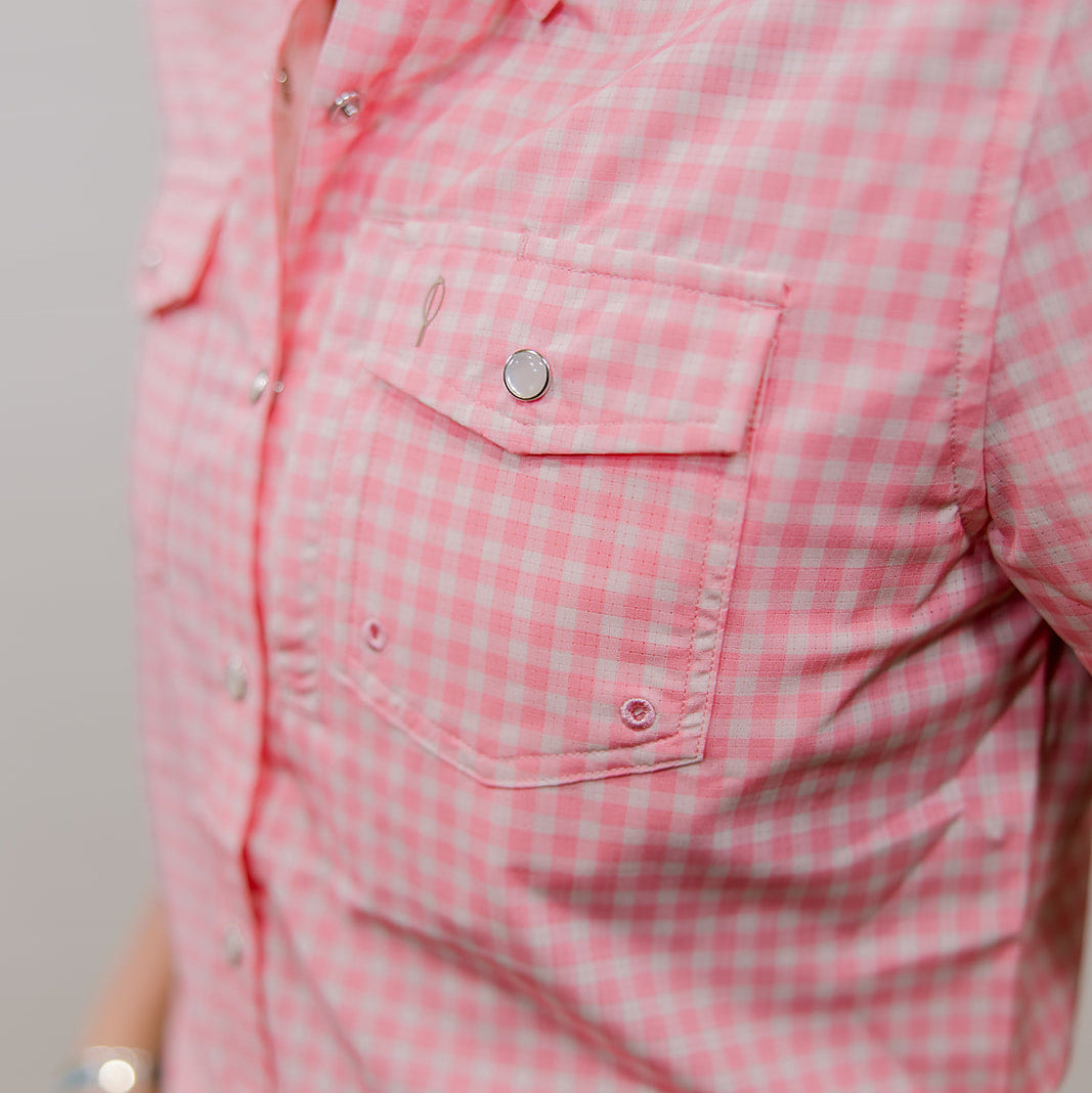 Close-up of a pink checkered shirt with a pocket and buttons. side facing