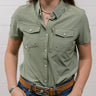 Woman wearing a sage green shirt and blue jeans against a white background showing the front 