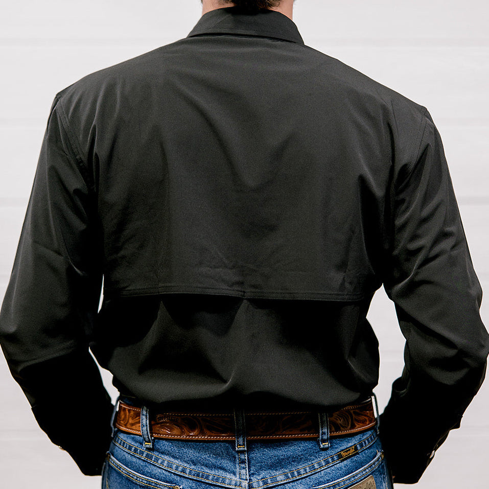 Man wearing a black shirt and blue jeans against a white background. back facing.