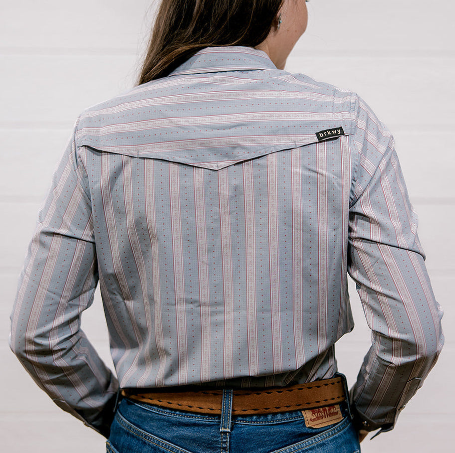 Person wearing a rangevent striped shirt and jeans from behind on a white background showing the back