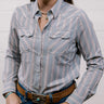 Woman wearing a rangevent striped shirt and jeans against a plain background showing the front