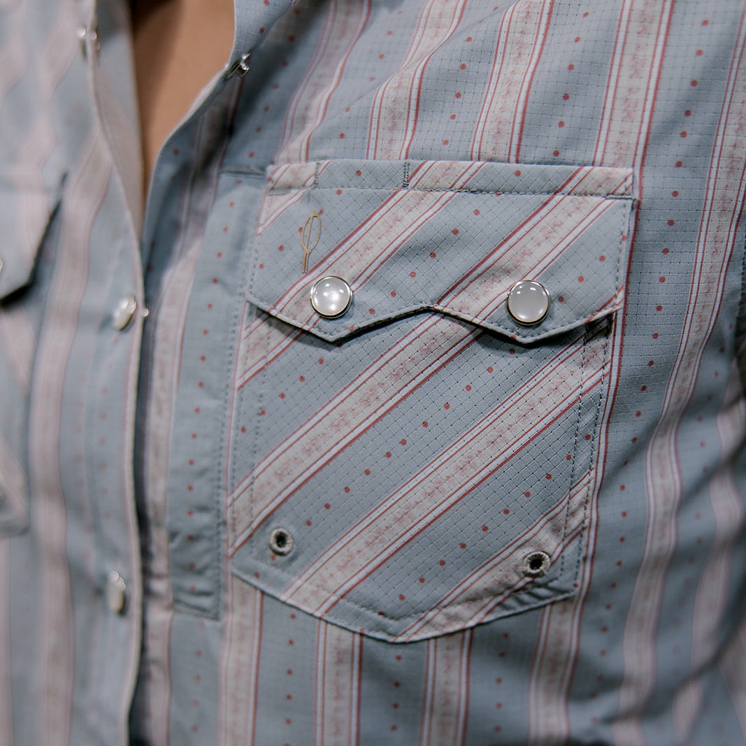 Close-up of a rangevent patterned shirt with a pocket and brand logo