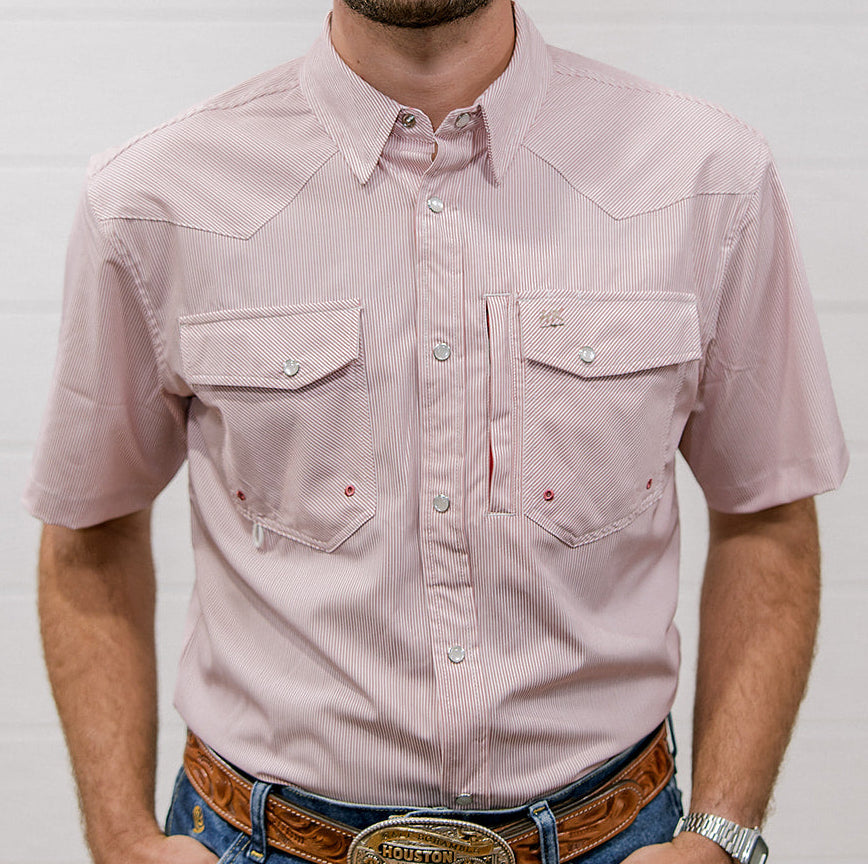 Man wearing a mauve striped shirt and blue jeans with a belt buckle, standing against a plain background. Front facing. 