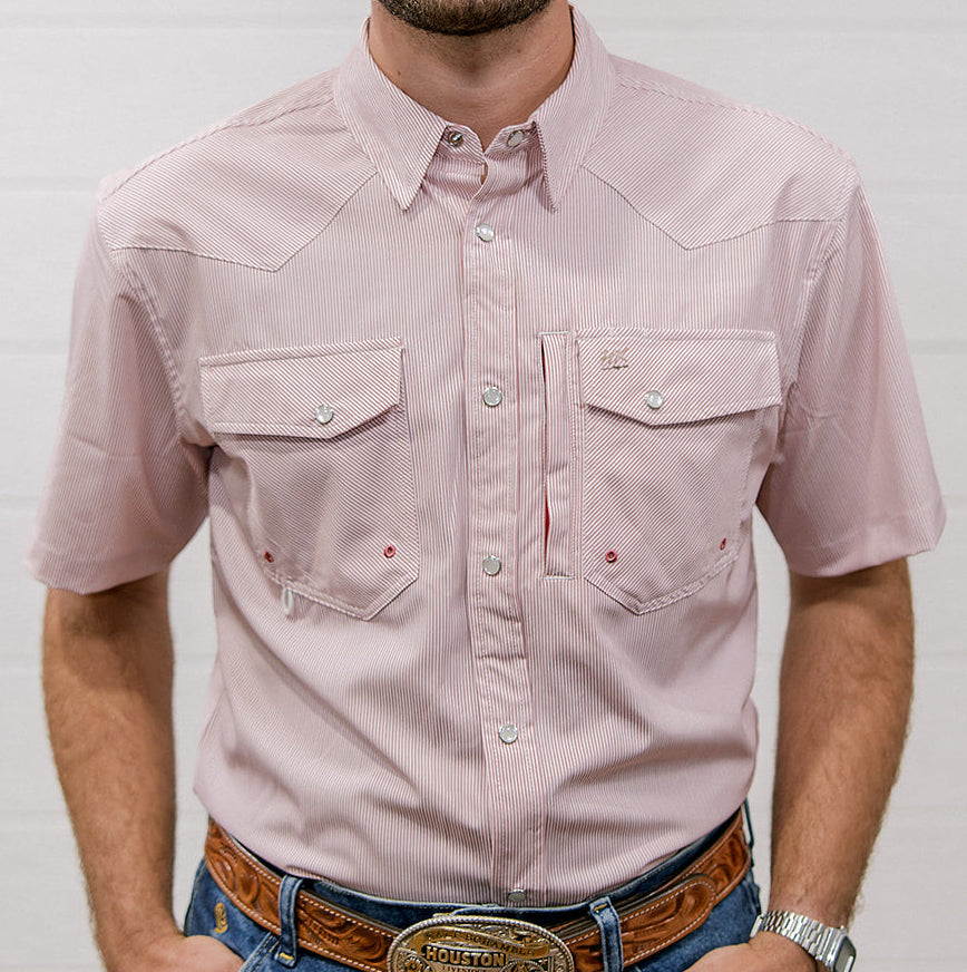 Man wearing a mauve striped shirt and blue jeans with a belt buckle, standing against a plain background. Front facing. 