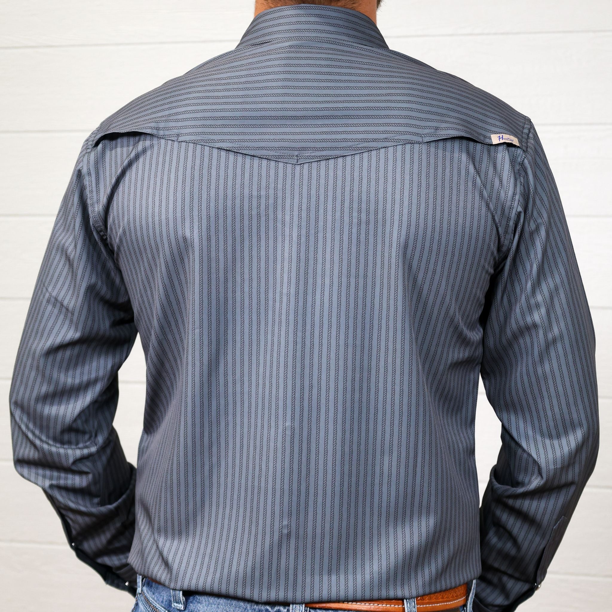 Back Grey striped shirt with two front pockets and pearl snaps on a white background
