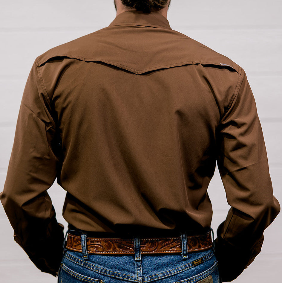 Man wearing a brown shirt and blue jeans against a white background. back facing.