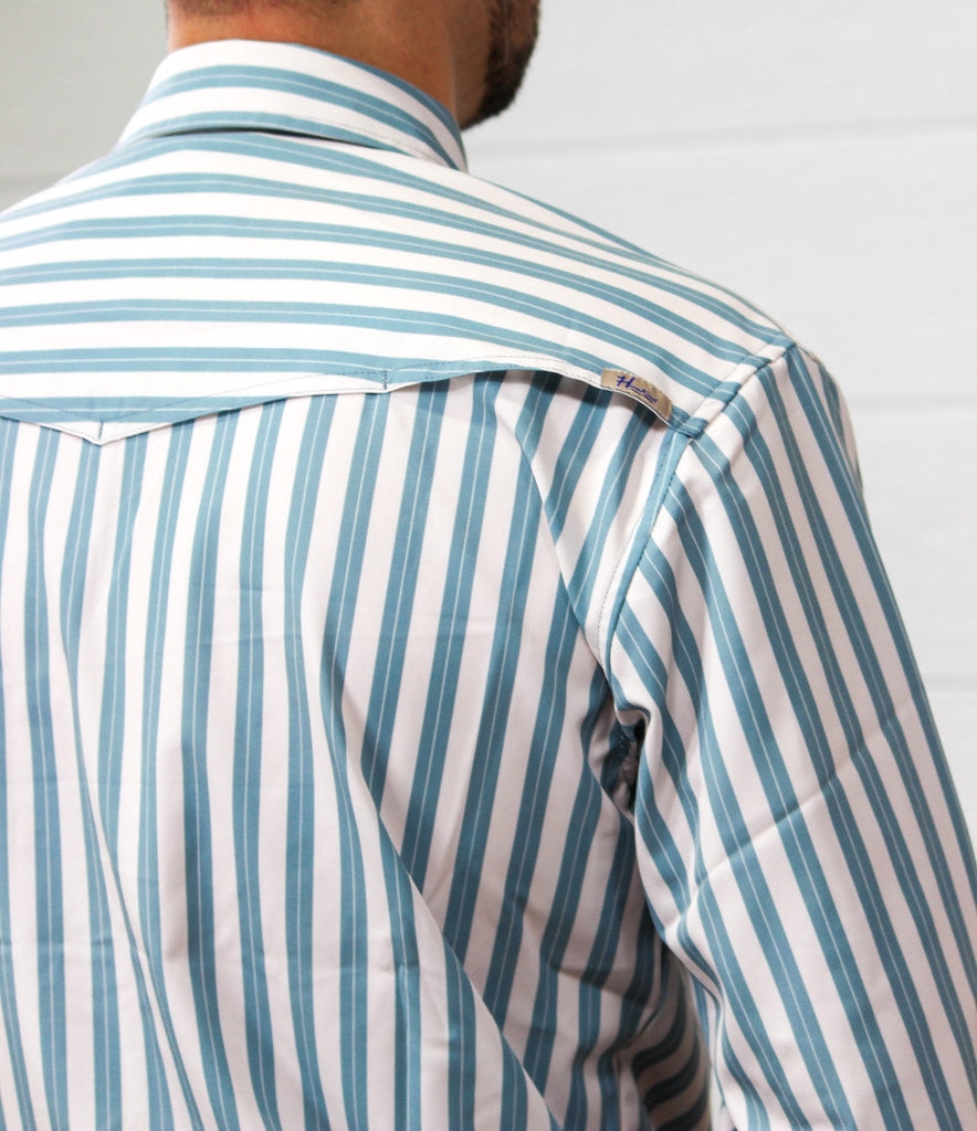Close-up back view of a man wearing a long-sleeve button-down shirt with vertical blue and white stripes, showing the shoulder and collar area.