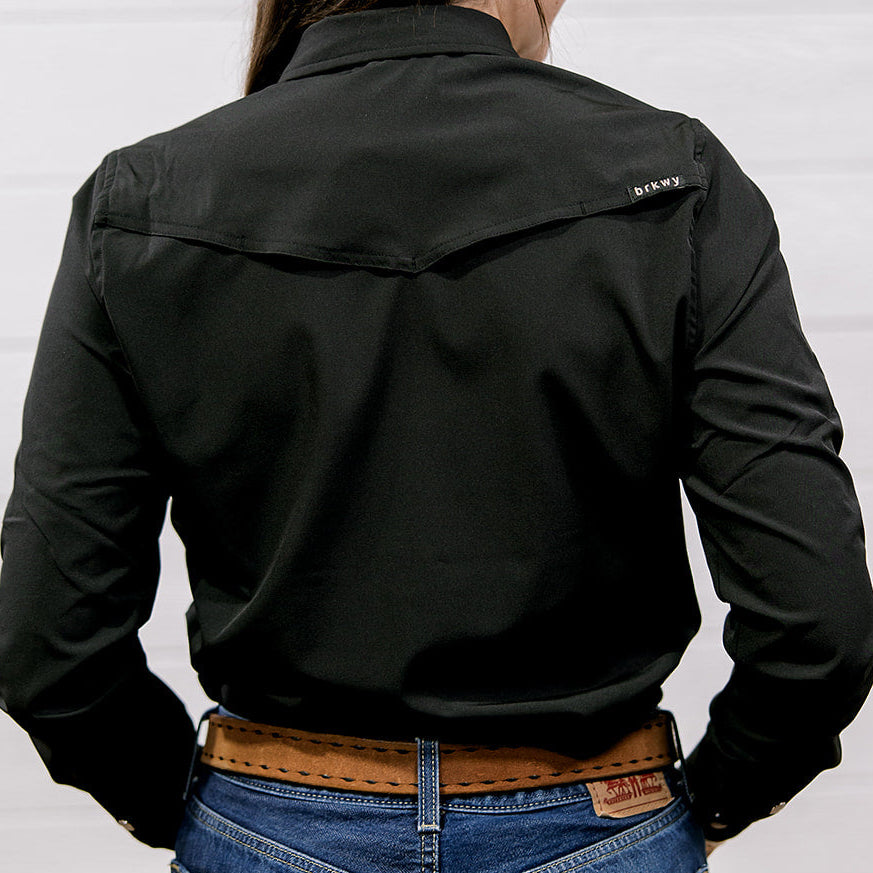 Person wearing a black shirt with a brand logo on a white background. back facing.