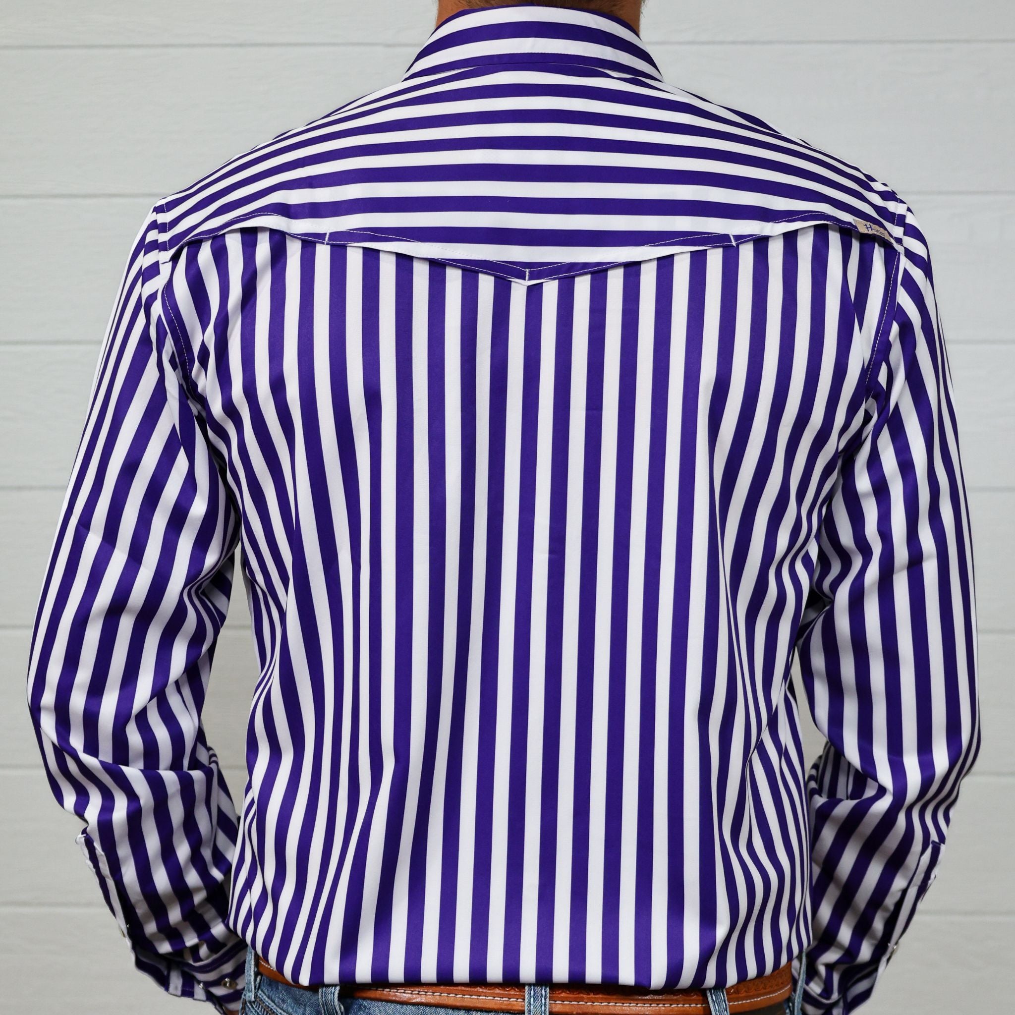 Purple and white striped long sleeve shirt worn by a person against a white background