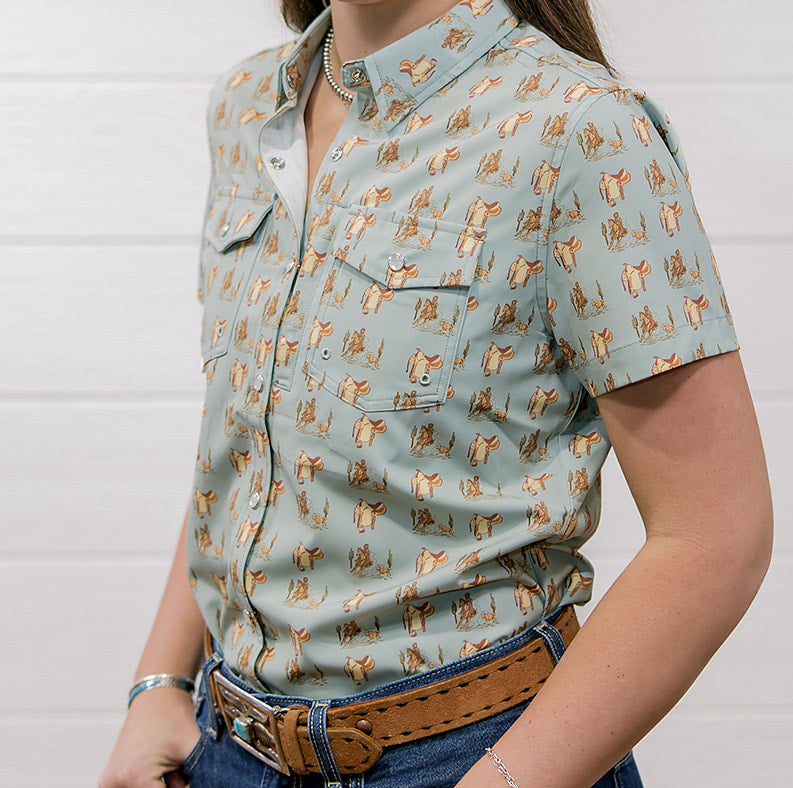 Woman wearing a western patterned shirt and jeans against a white background showing the front