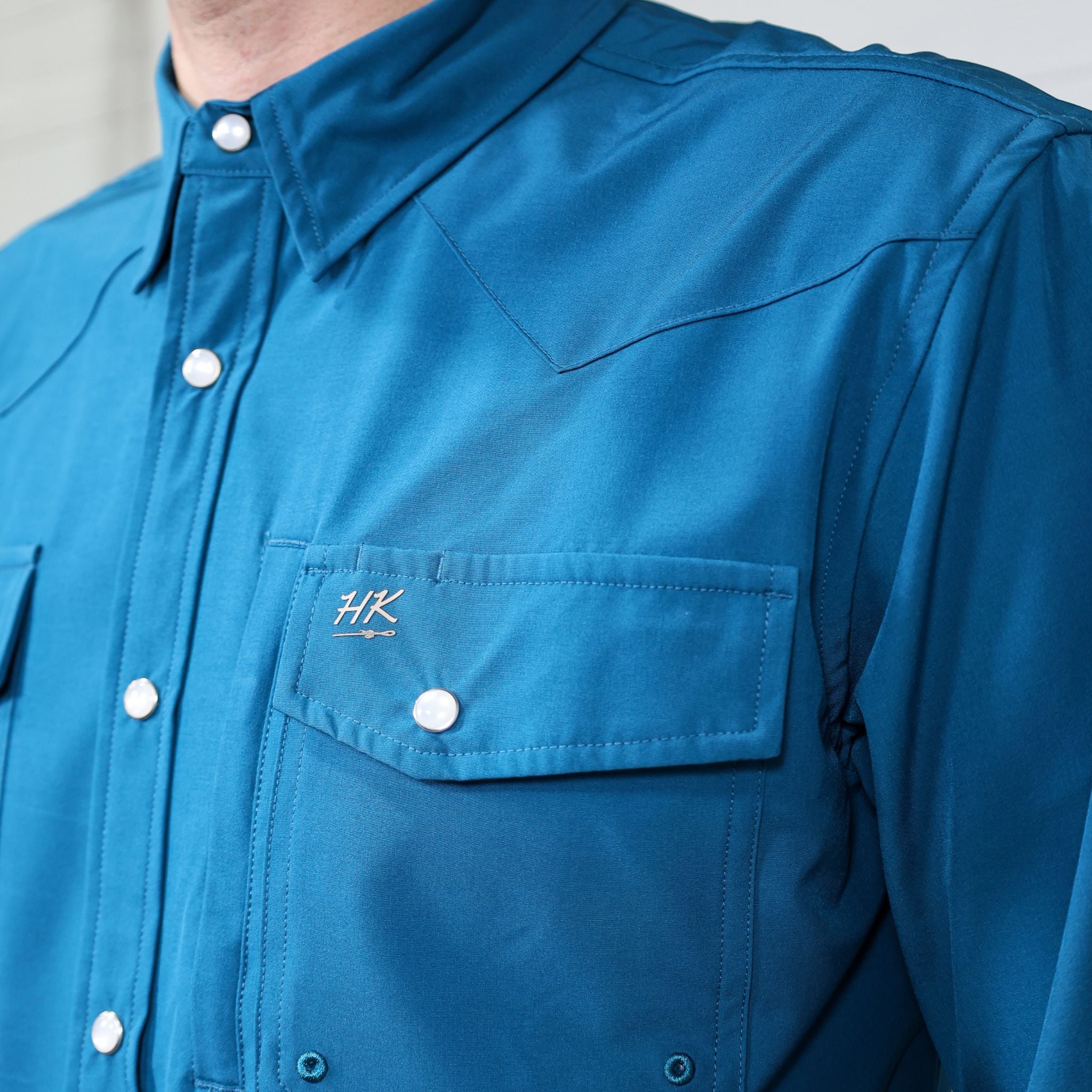  The teal tie down shirt showing the pocket and the logo 