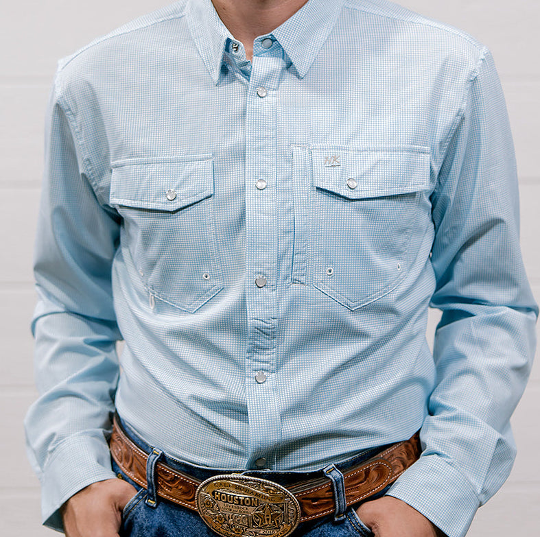 Man wearing a light blue denim shirt and jeans against a plain background. Front Facing