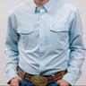 Man wearing a light blue denim shirt and jeans against a plain background. Front Facing