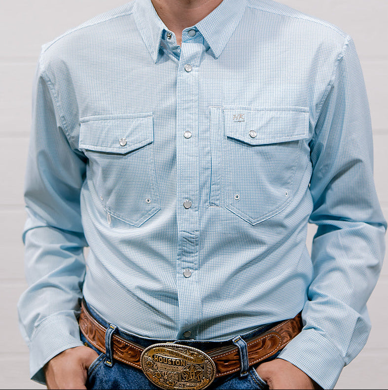Man wearing a light blue denim shirt and jeans against a plain background. Front Facing