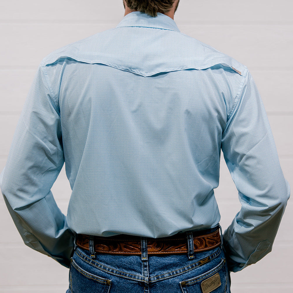 Man wearing a light blue shirt and jeans from behind on a plain background. Back Facing.