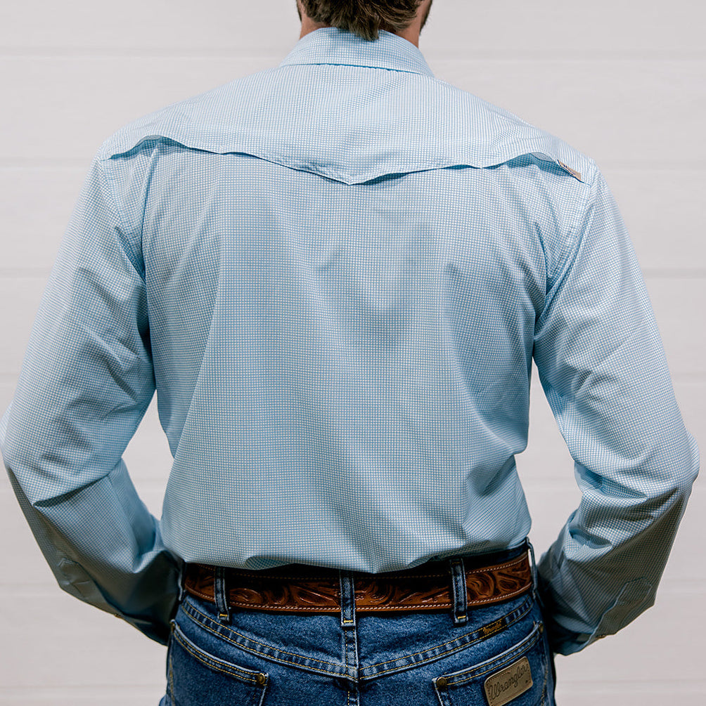 Man wearing a light blue shirt and jeans from behind on a plain background. Back Facing.