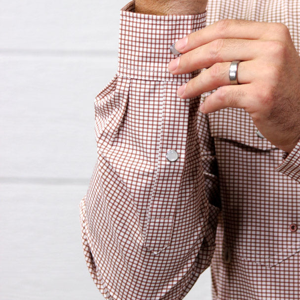 Up close of arm buttoning pearl snaps
