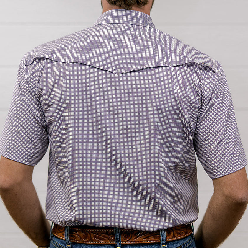 Man wearing a light purple short-sleeve shirt and blue jeans against a white background. back facing.
