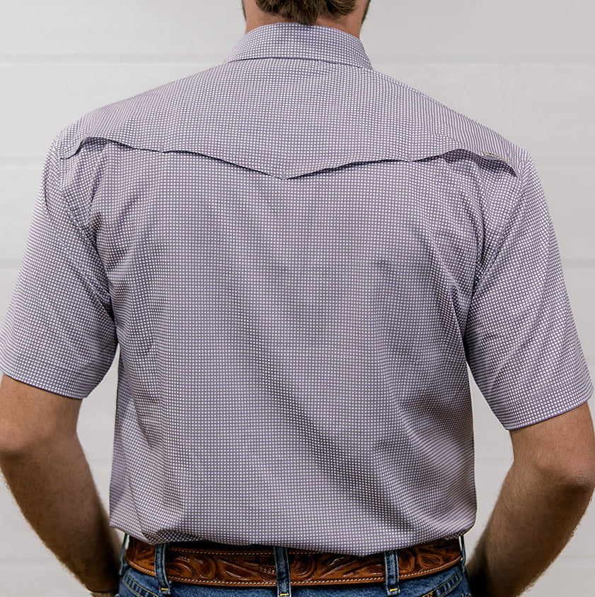 Man wearing a light purple short-sleeve shirt and blue jeans against a white background. back facing.