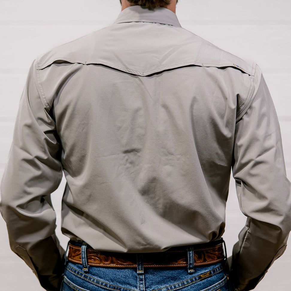 Man wearing a light gray shirt and blue jeans with a white background. back facing.